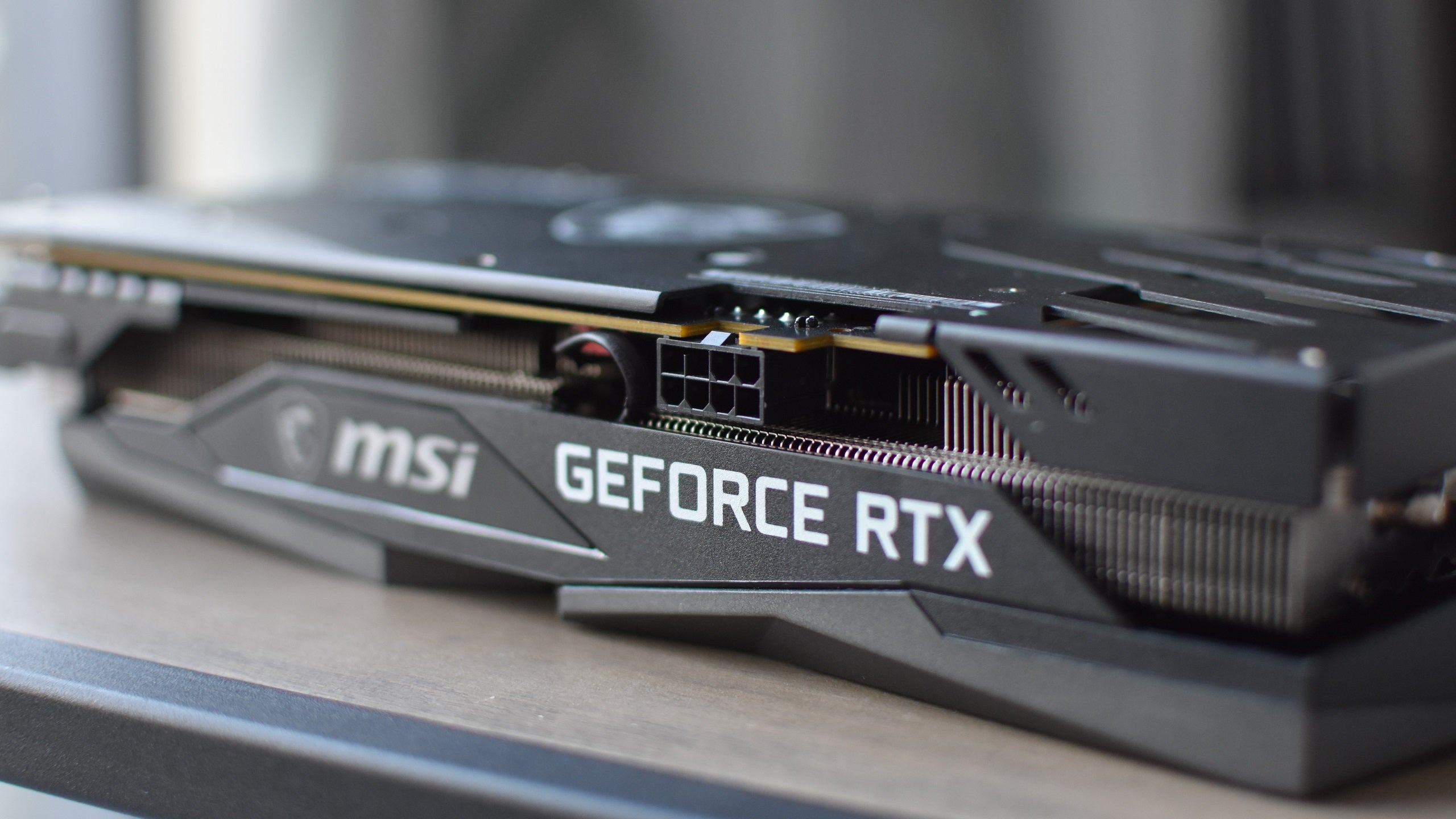 A close-up of the MSI GeForce RTX 3060 Gaming X Trio, showing the power connector.