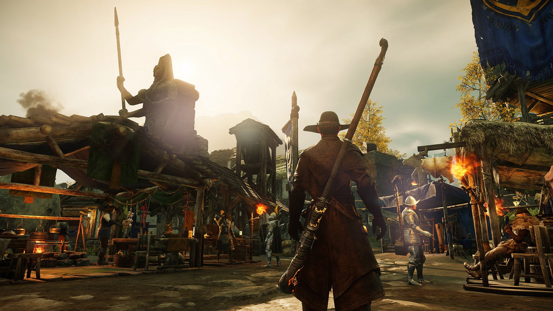 New World: A character in leather armor and a broad-brimmed hat stands silhouetted against a bright sky, looking over the crafter's alley in a town.