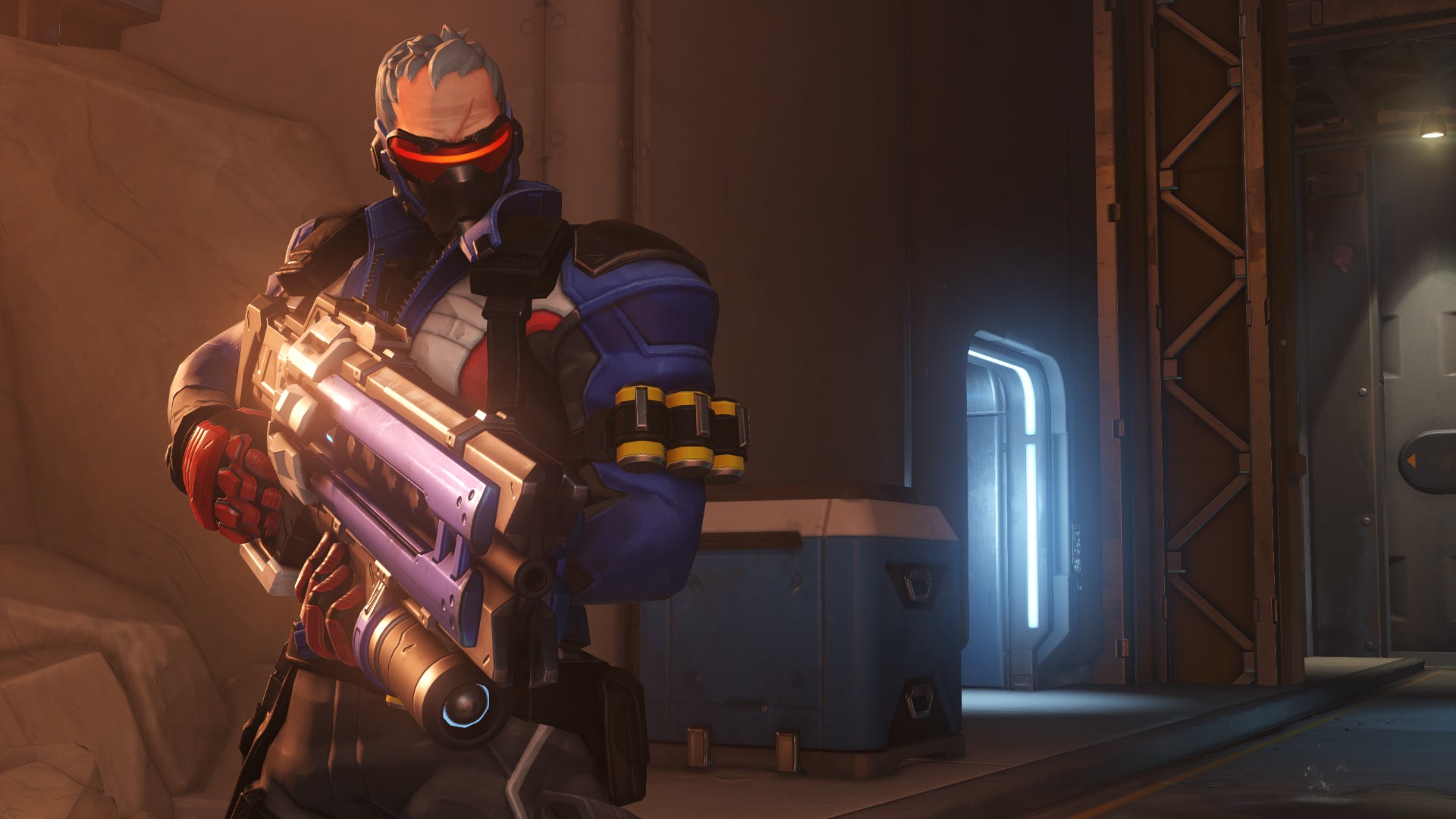 Soldier: 76, a hero in Overwatch 2, stands in front of the camera on the left-hand side, holding his assault rifle.