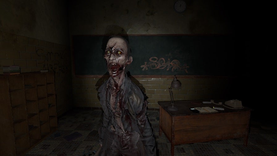 Phasmophobia photograph of a ghost: an oni with yellow eyes, a screaming mouth, and torn clothes stands close to the player in a high school classroom.