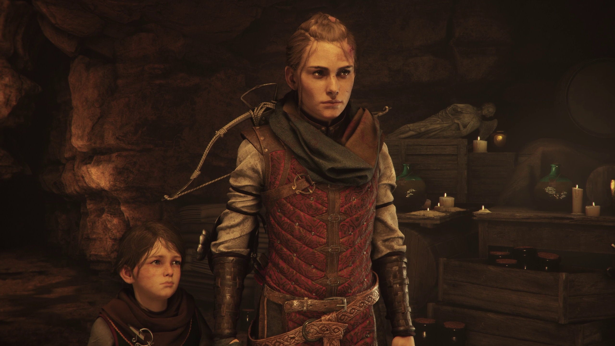 A girl in medieval clothes stands in front of her young brother in A Plague Tale: Requiem.