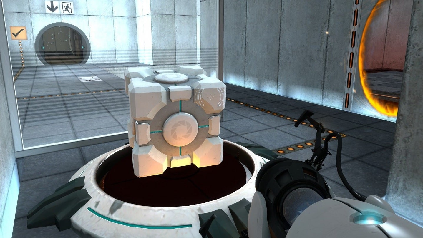 Portal - A player points their portal gun at a companion cube that's been placed on top of a large button. An orange portal is open on a wall on their right.