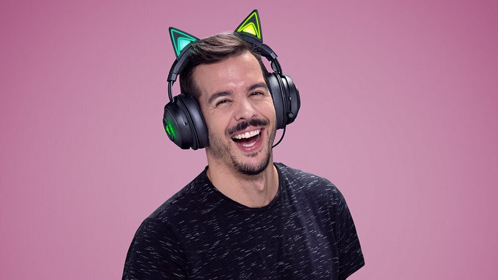 A photograph of a man unreasonably happy to be wearing the Razer Kraken Kitty headphones.