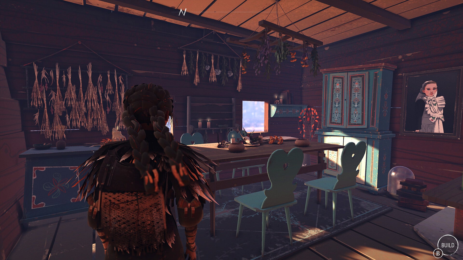 A Reka screenshot showing the inside of a cosy cottage complete with hanging herbs and a dinning table.