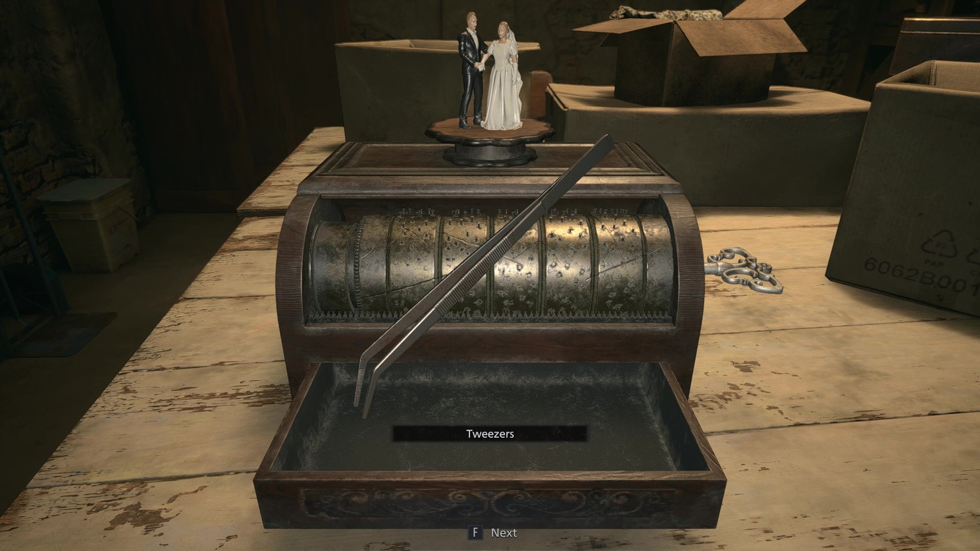 An image of the solved music box puzzle, with the reward being a pair of tweezers.
