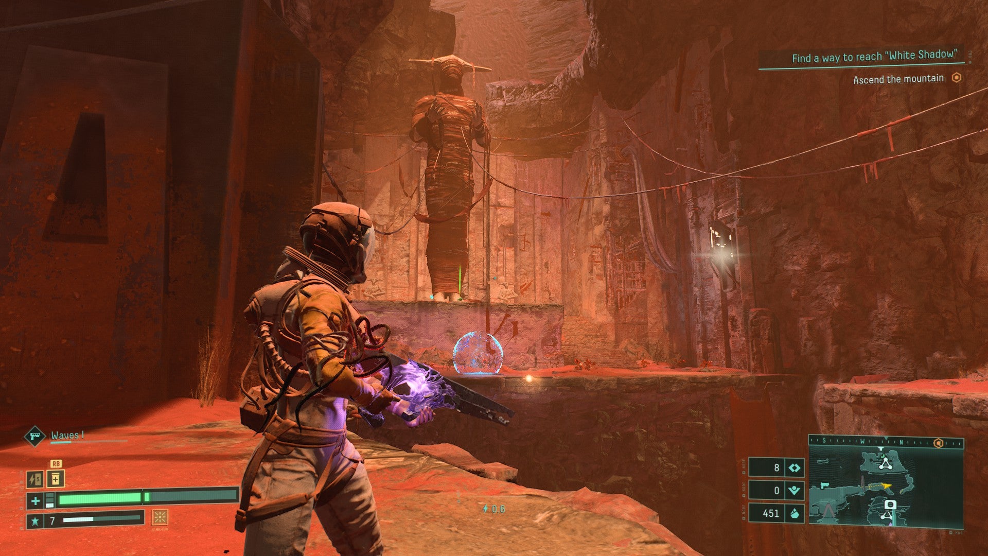 A Returnal screenshot shows Selene next to a deep gorge with a giant statue in the distance.