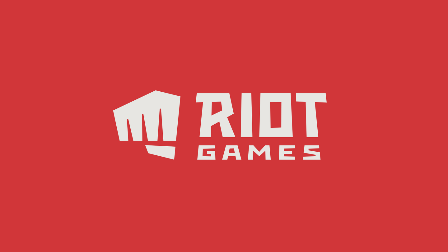 An image of the Riot Games logo, showing white text which reads "Riot Games" next to a clenched white fist against a red background.