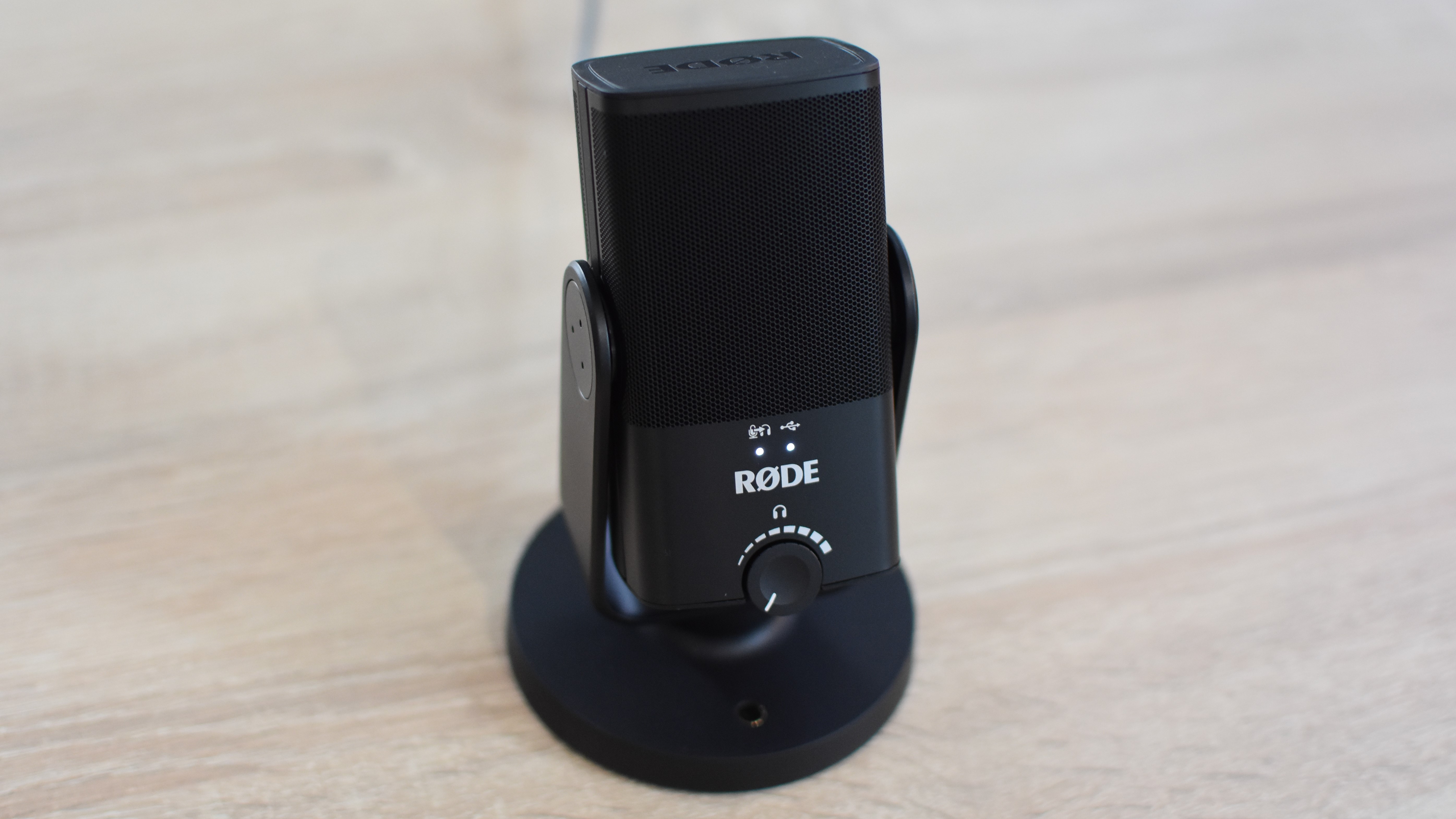 The Rode NT-USB Mini microphone on a desk.