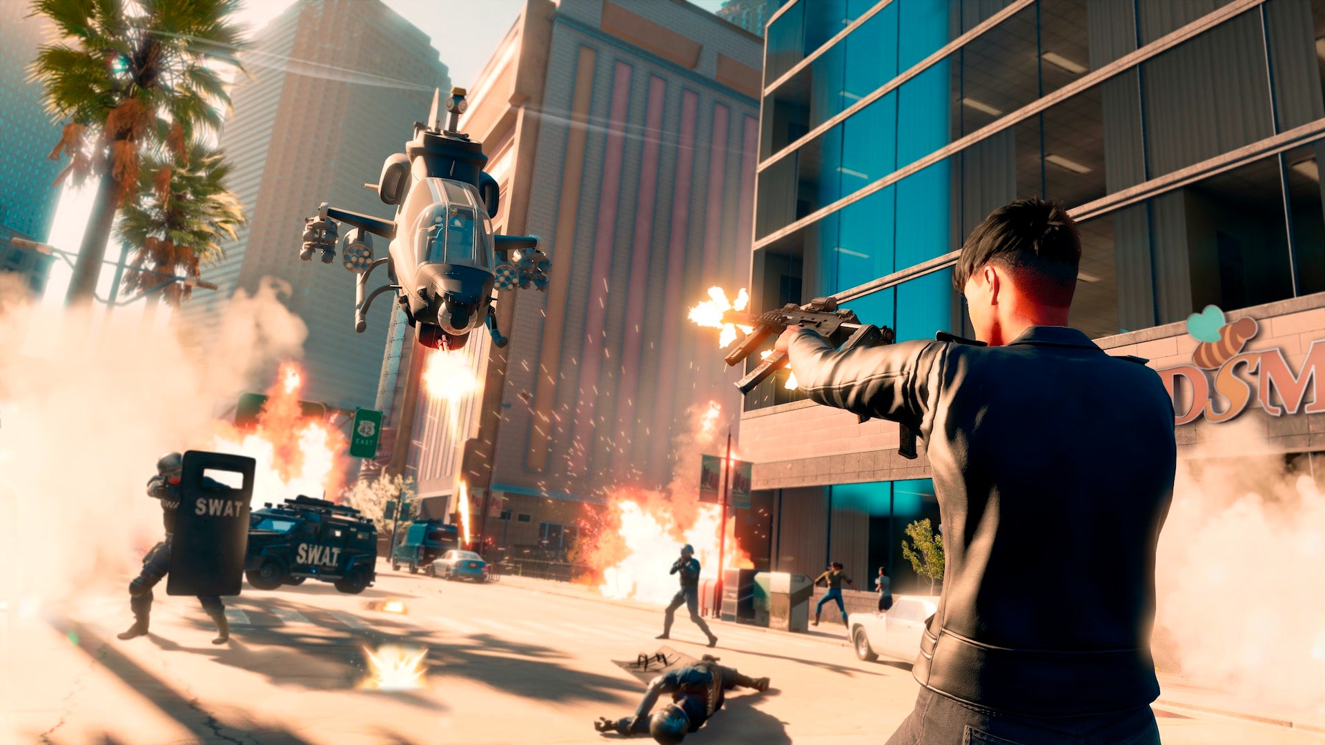 The player fires uzis at a helicopter while all-round chaos ensues in Saints Row.