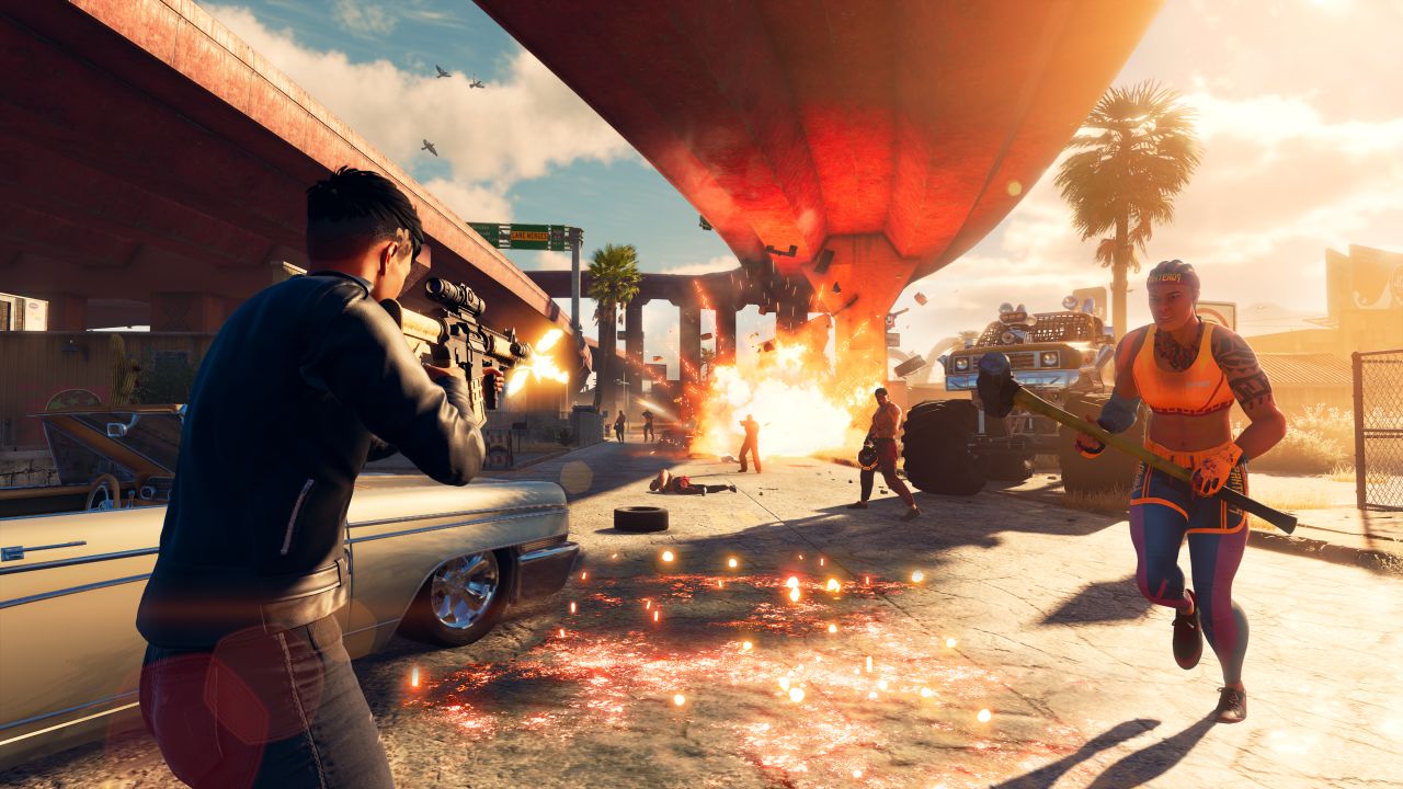 A combat scene in the new Saints Row reboot, taking place under a freeway bridge. There is an explosion in the background as the player character shoots at rival gang members