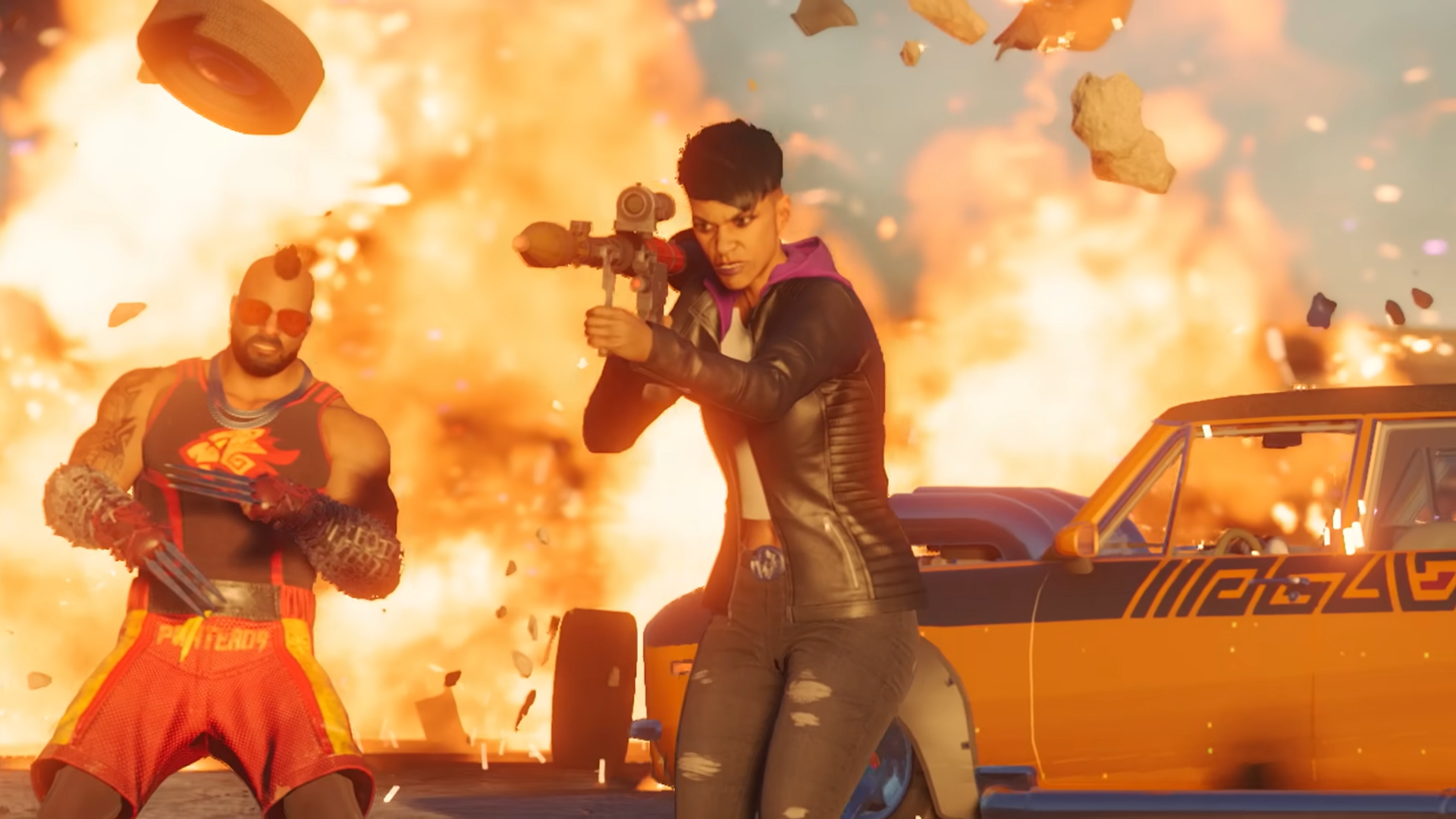 A Boss from Saints Row aims a rocket launcher off-camera, while in the background a car explodes into flames and another gang member reacts.