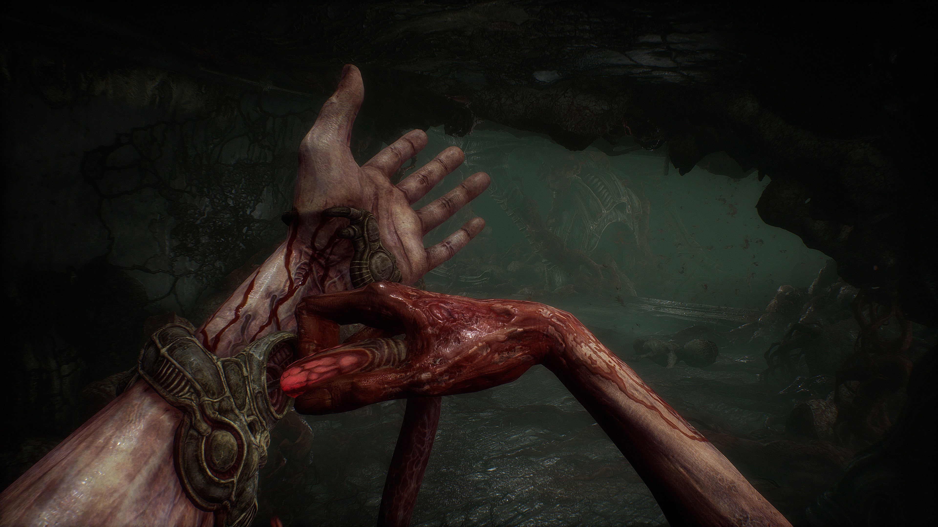 Popping some sort of gemstone into or out of your wrist in first-person horror game Scorn.