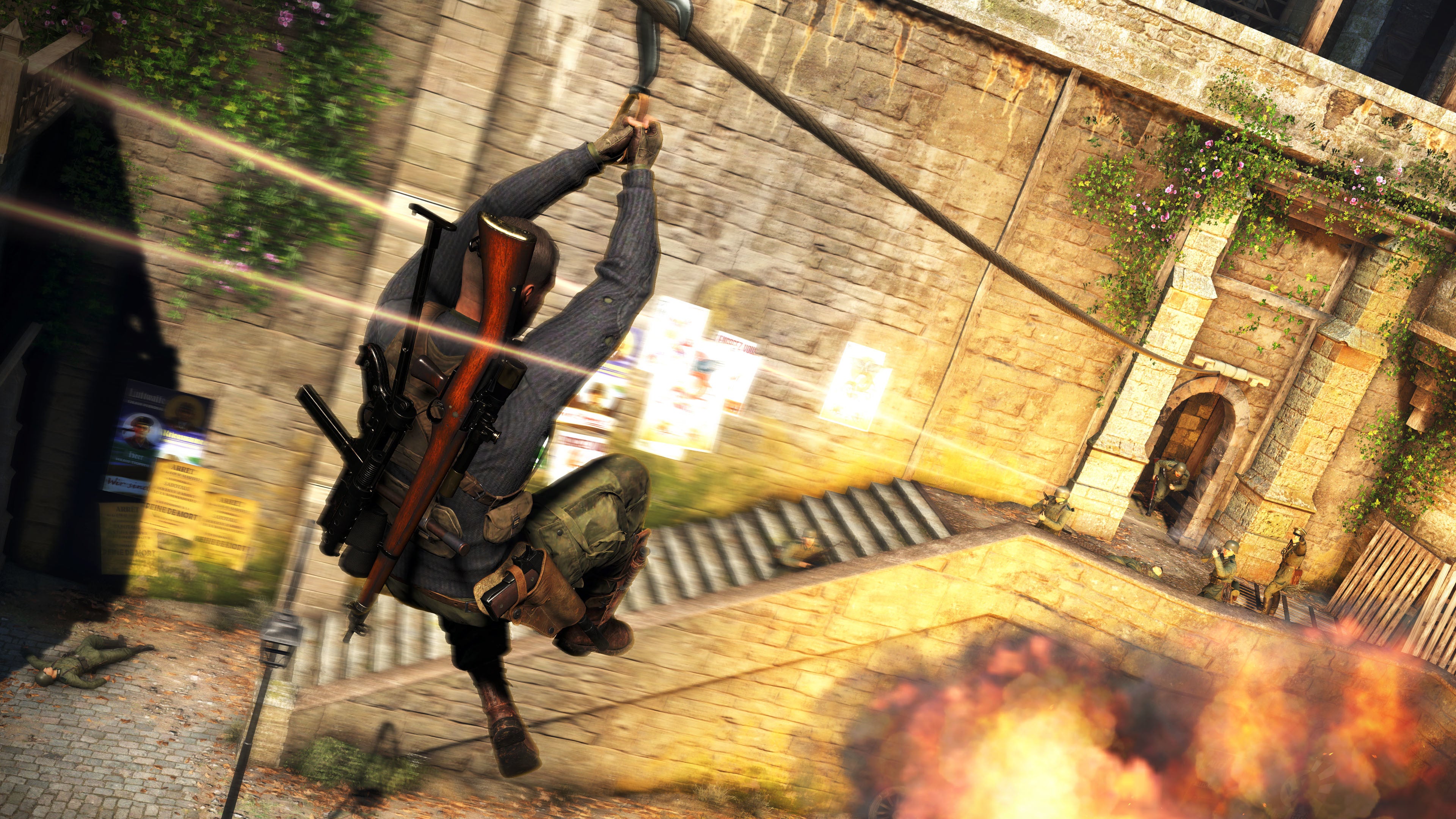 A screenshot of Sniper Elite 5 showing the player ziplining over an explosion and directly towards five or more firing Nazis.