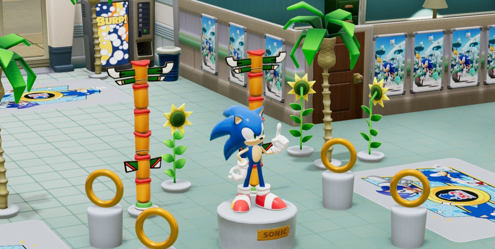 A screenshot of a hospital filled with rings, a Sonic statue, and Sonic posters in Two Point Hospital.