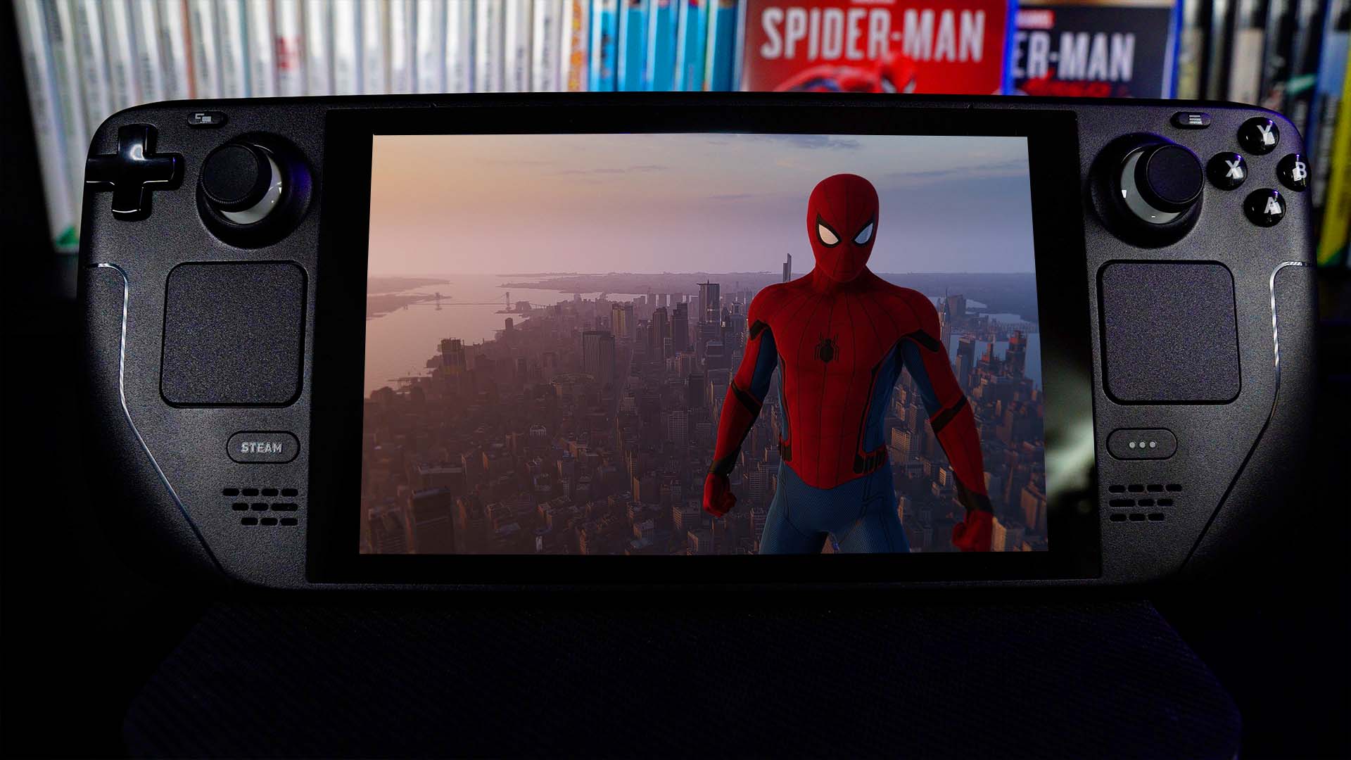A Steam Deck displays a picture of Spider-Man standing on top of a skyscraper with New York sprawling out behind them.