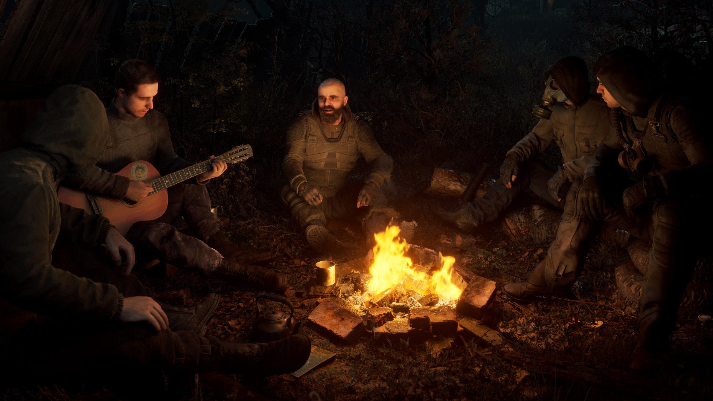 Scavengers gathered round a campfire in a S.T.A.L.K.E.R. 2 screenshot.