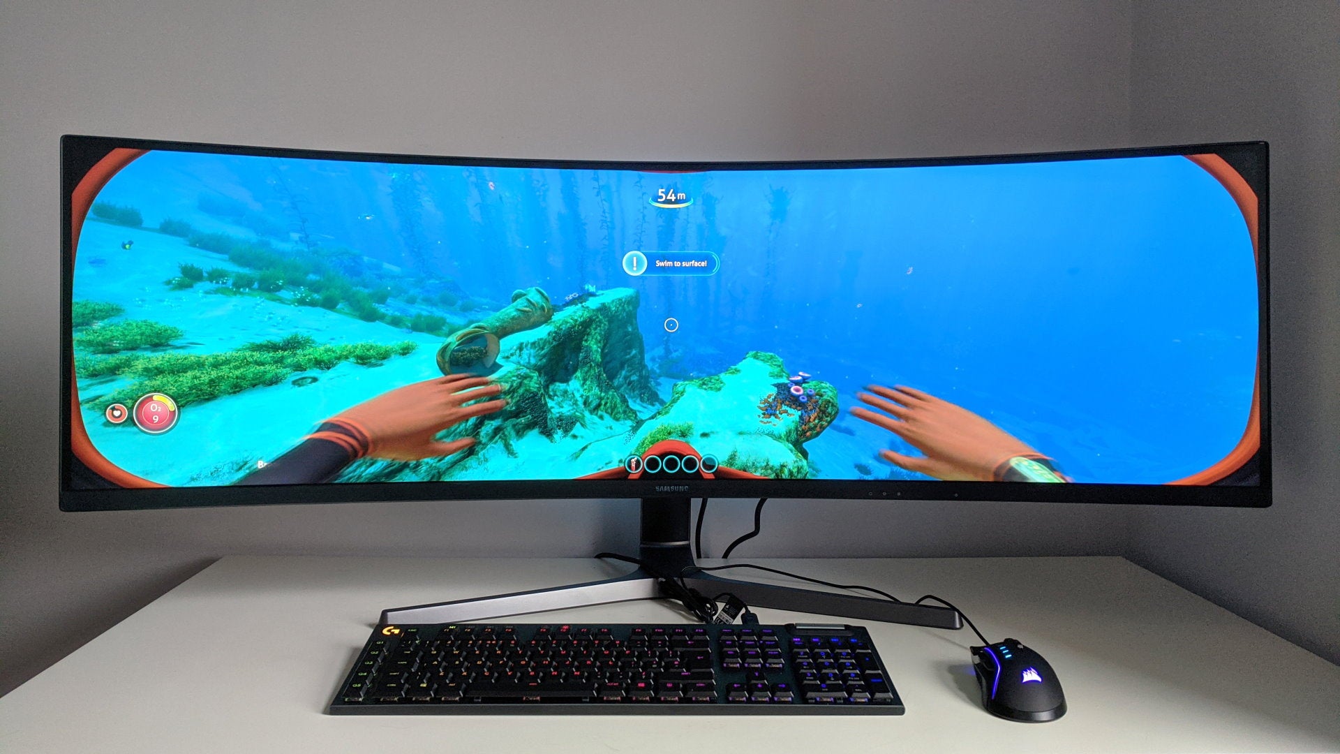 A photo of an ultrawide gaming monitor running Subnautica