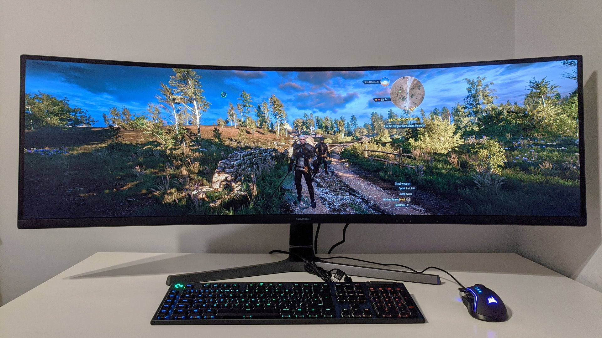 A photo of an ultrawide gaming monitor running The Witcher III