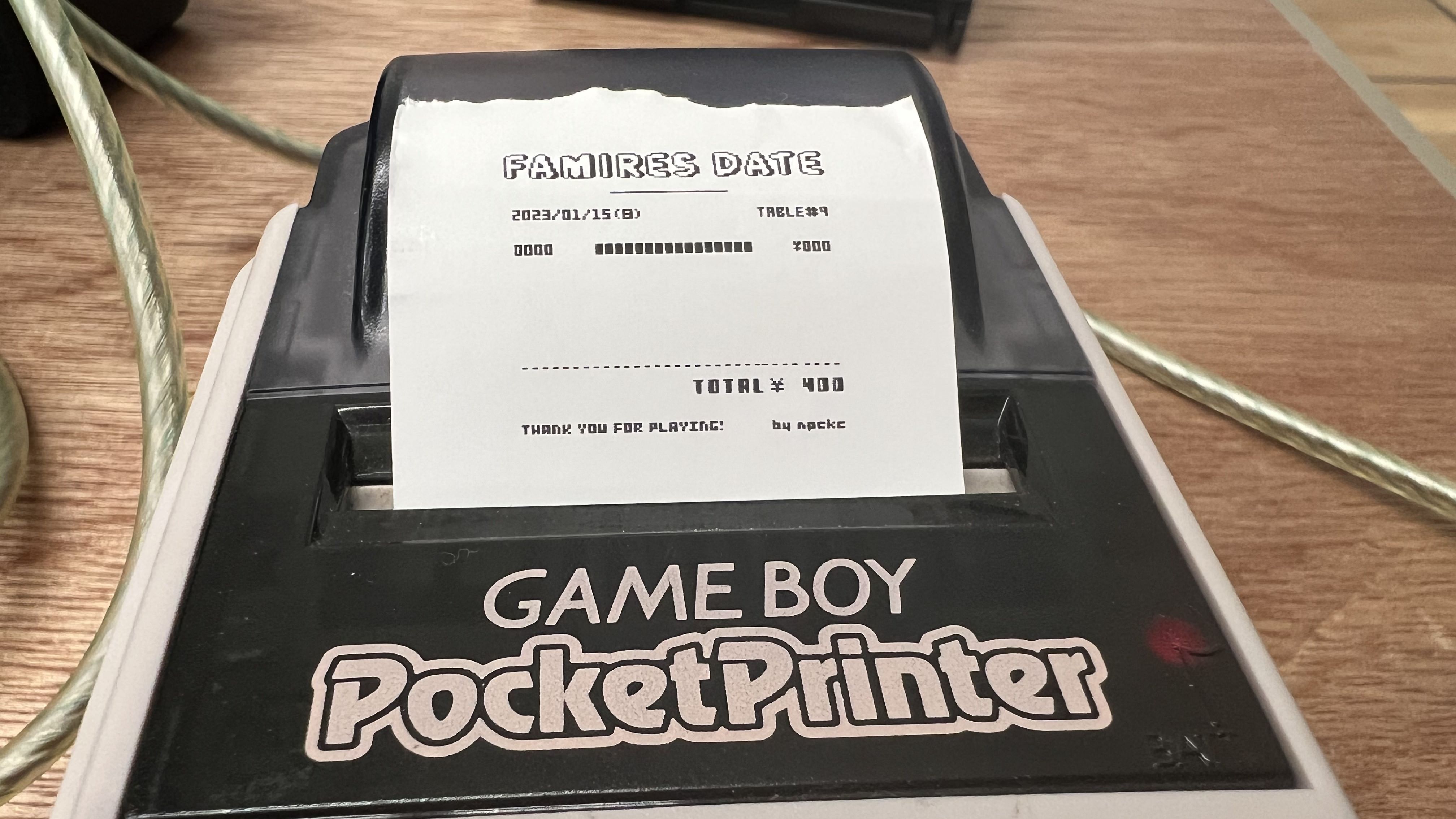 A receipt from a date in PC doujin game Famires Date, printing on a Game Boy PocketPrinter, shown at Tokyo Game Dungeon