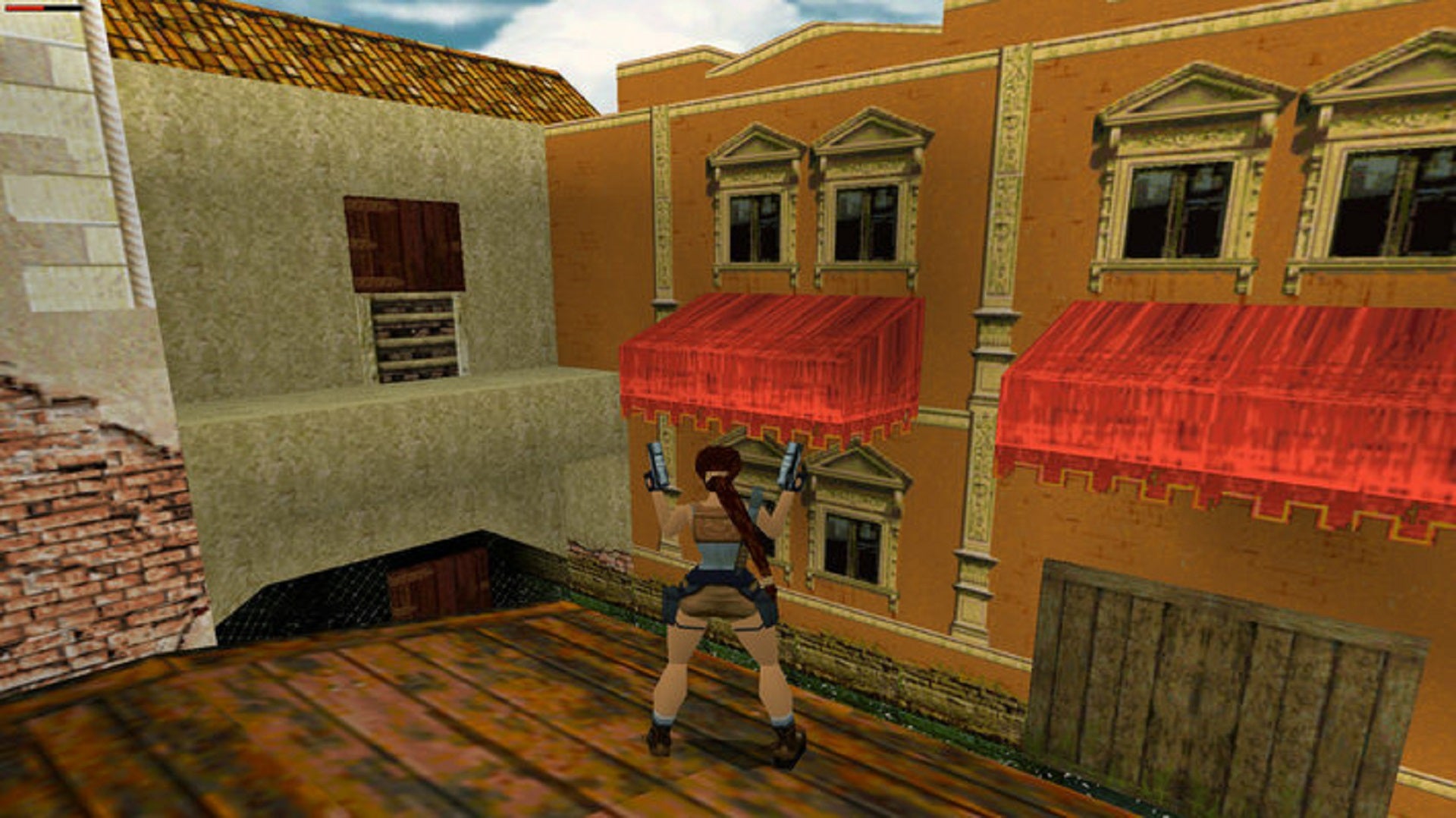 Lara Croft stands on the roof of a Venice dwelling wielding her dual pistols in Tomb Raider II.