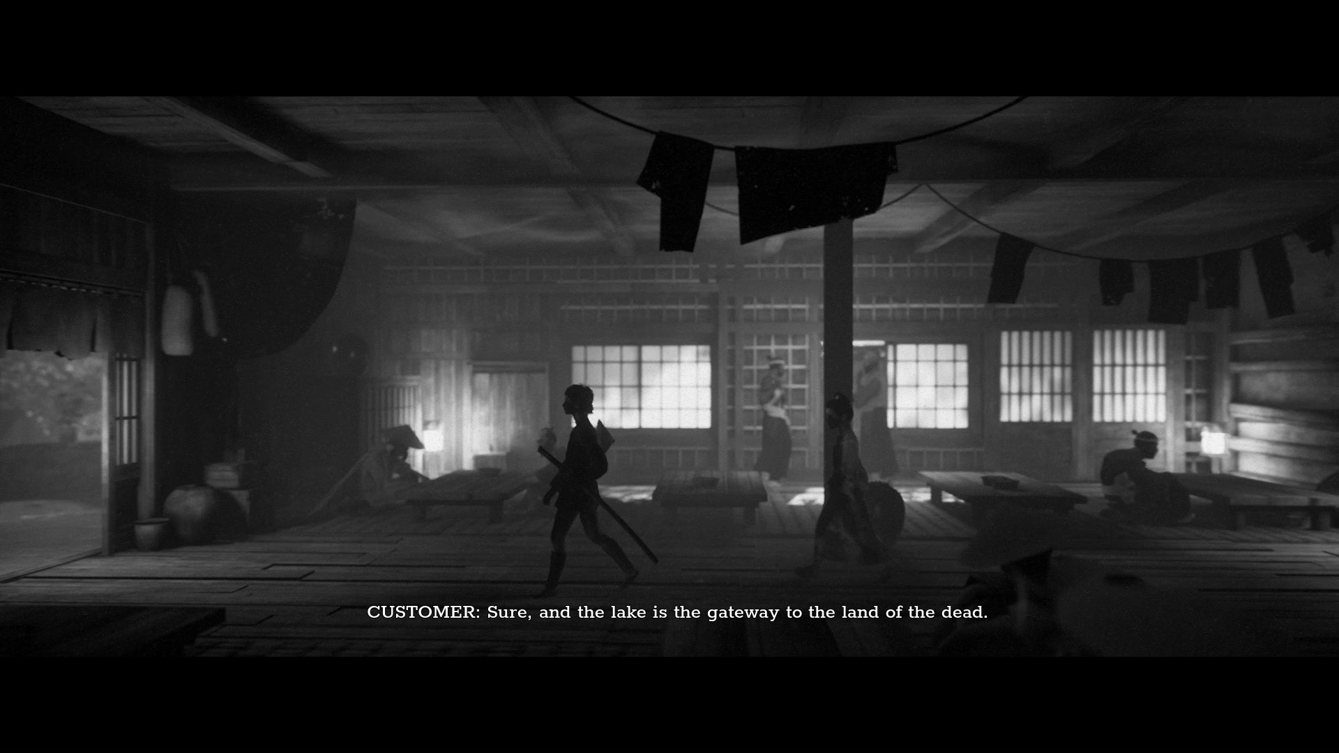 A screenshot from Trek To Yomi which shows a young Hiroki wander through a dark shop.