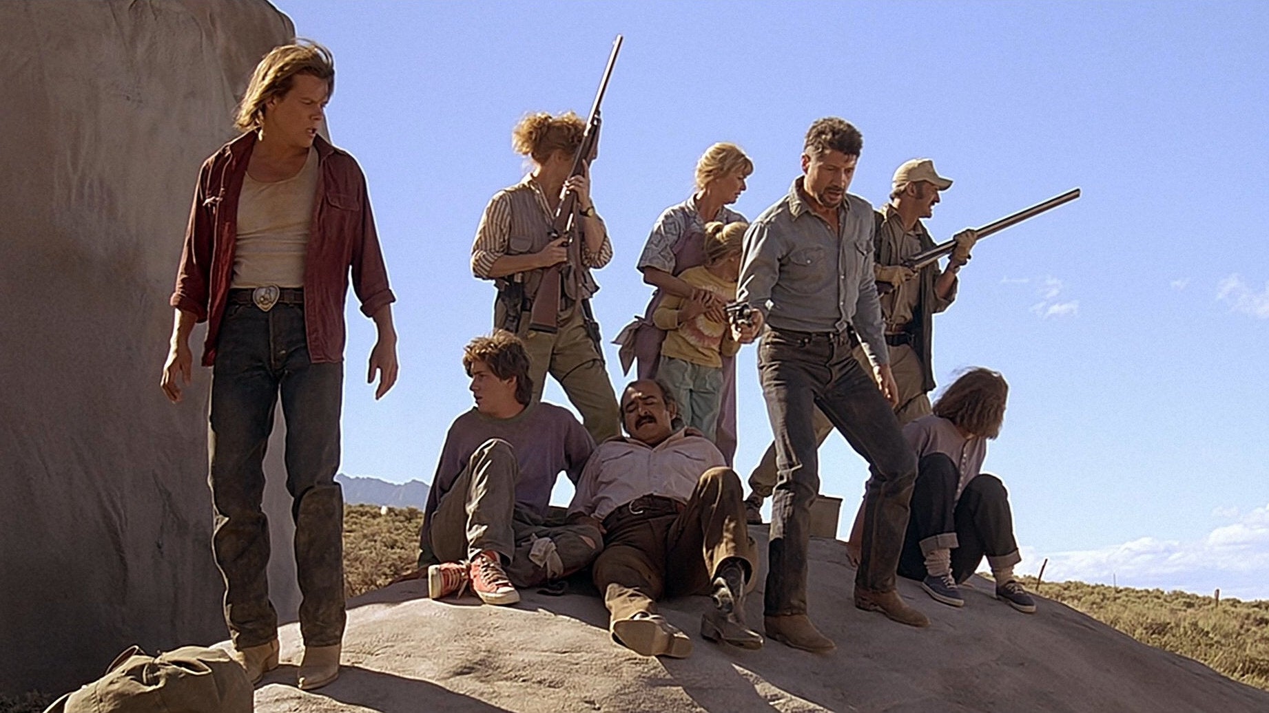 Kevin Bacon and friends hide on a rock in Tremors.