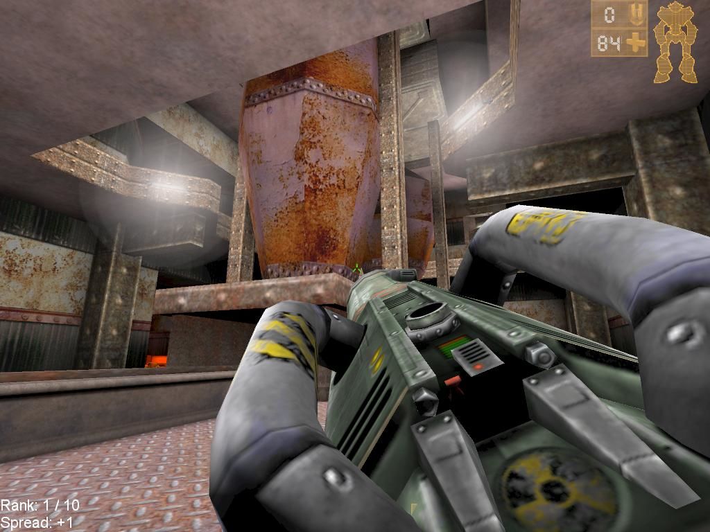A very large gun in pointed at an industrial container in Unreal Tournament