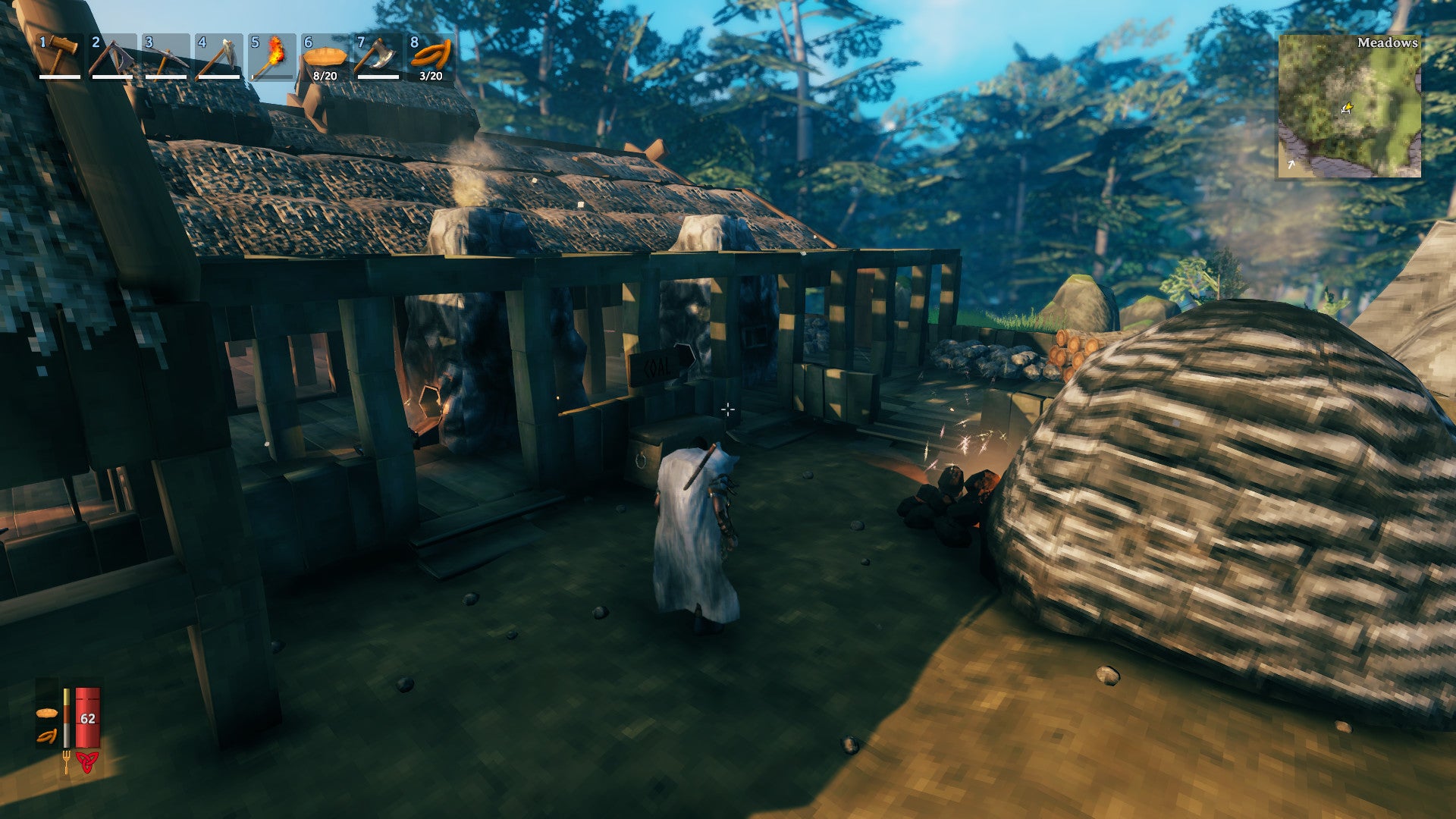 A Valheim screenshot of a player clad in a Wolf Cloak, walking towards the smelting area of a settlement.