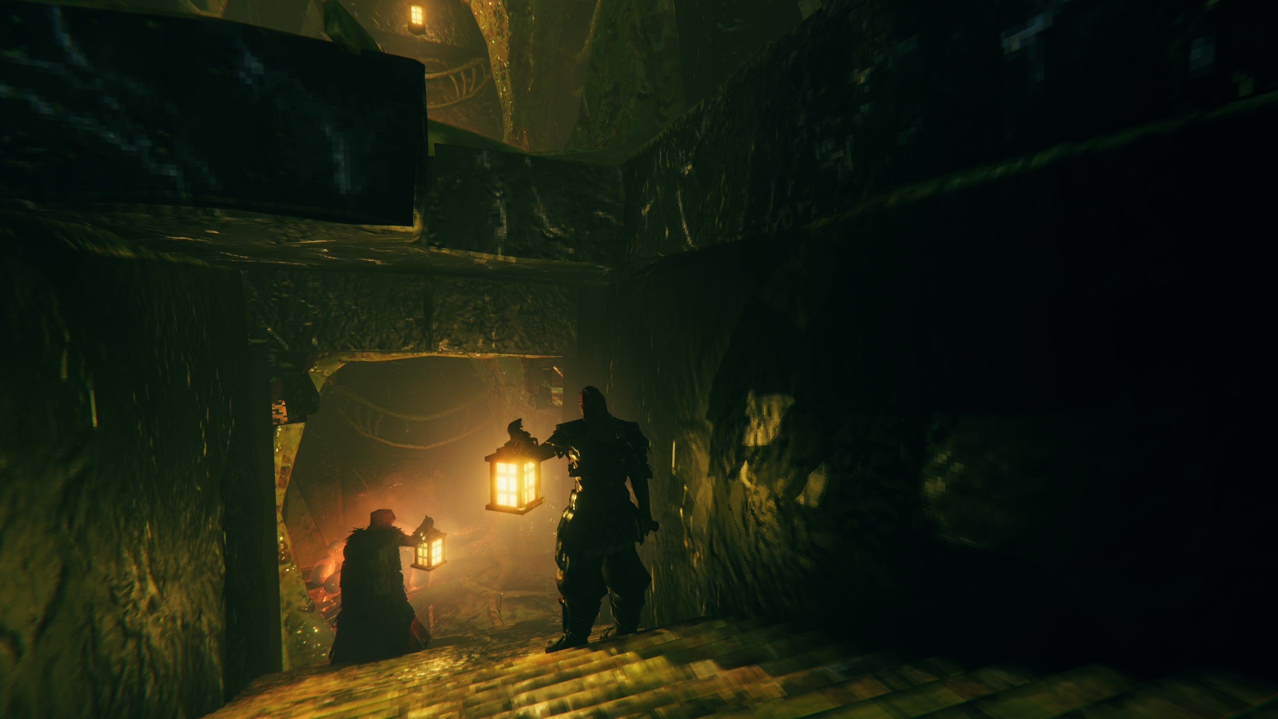 Two players hold lanterns to fend off the darkness of a Valheim Mistlands dungeon.