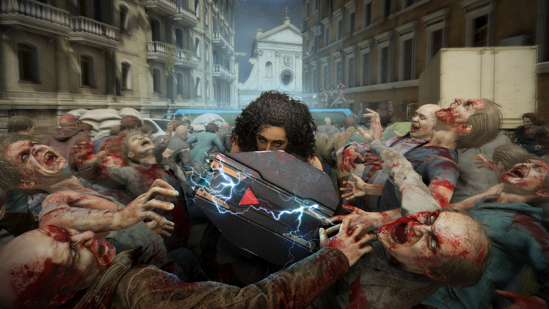A woman holds up a huge shield against hordes of zombies in World War Z