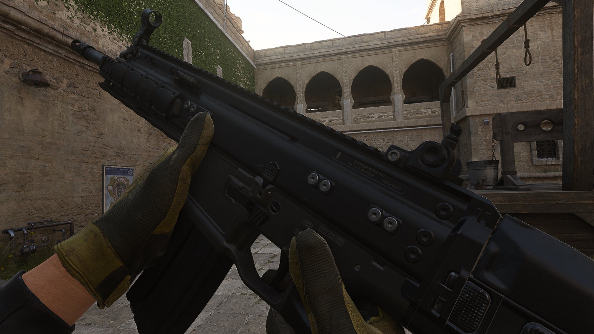 The player in Warzone 2.0 inspects their weapon, the TAQ-56.