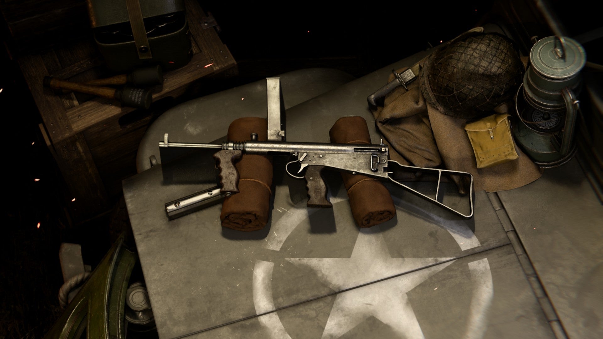 Owen Gun in the Vanguard weapon gunsmith loadout screen, on a crate surrounded with other weapons, explosives, and armour