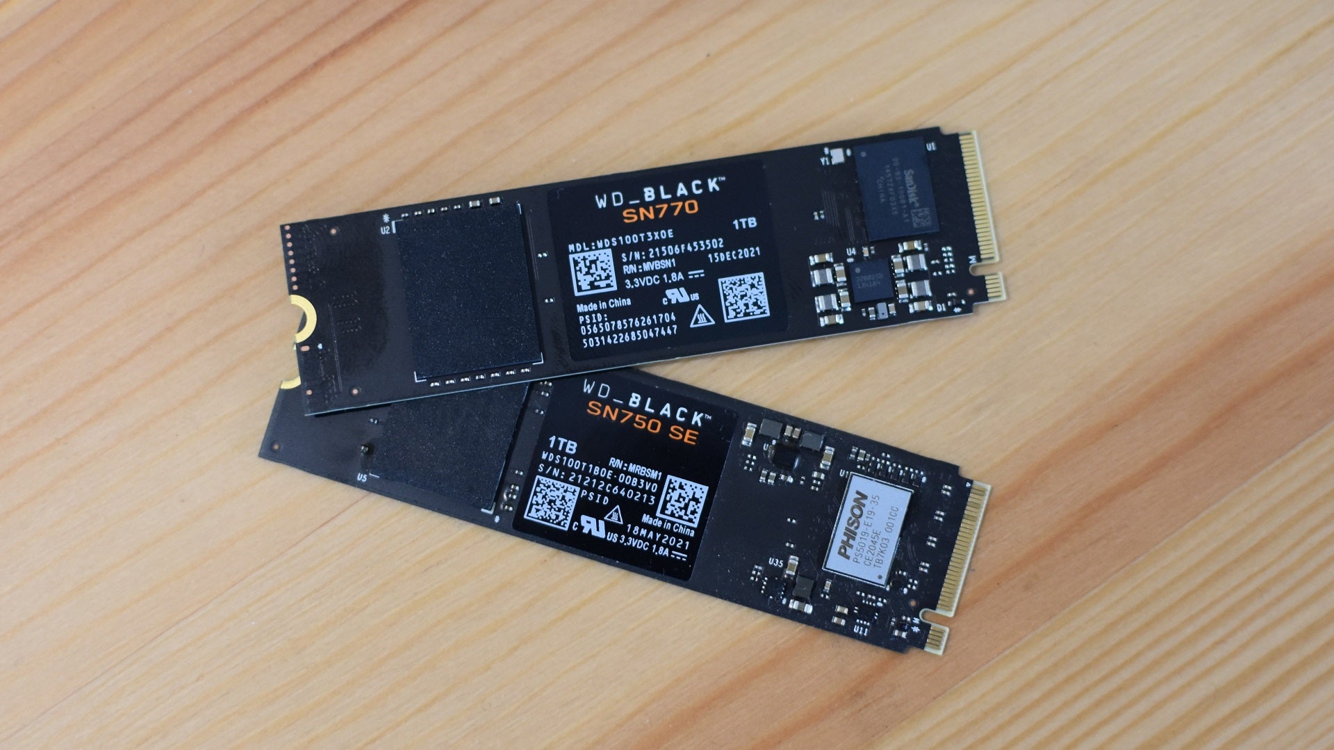 The WD Black SN770 SSD next to the WD Black SN750 SE.