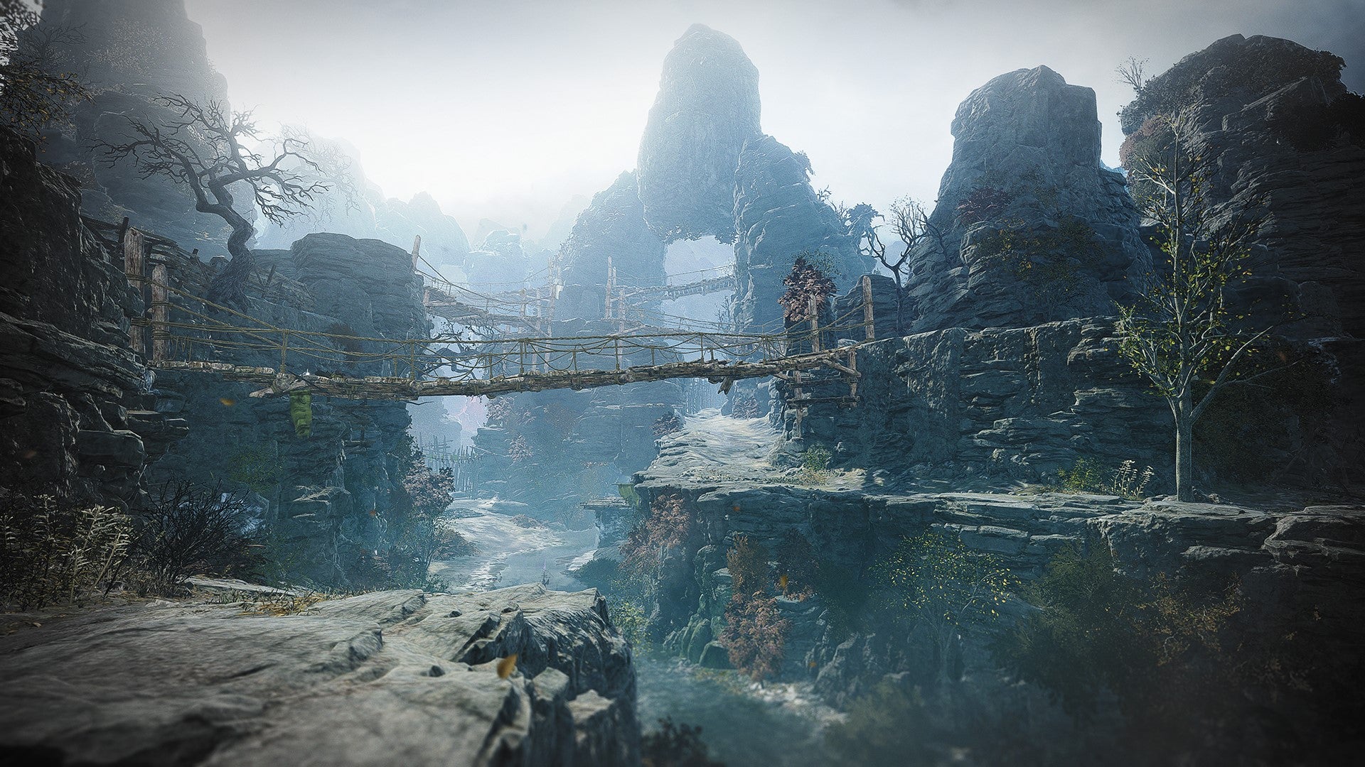 A mountainous environment with a rickety bridge running through its center in Wo Long: Fallen Dynasty.