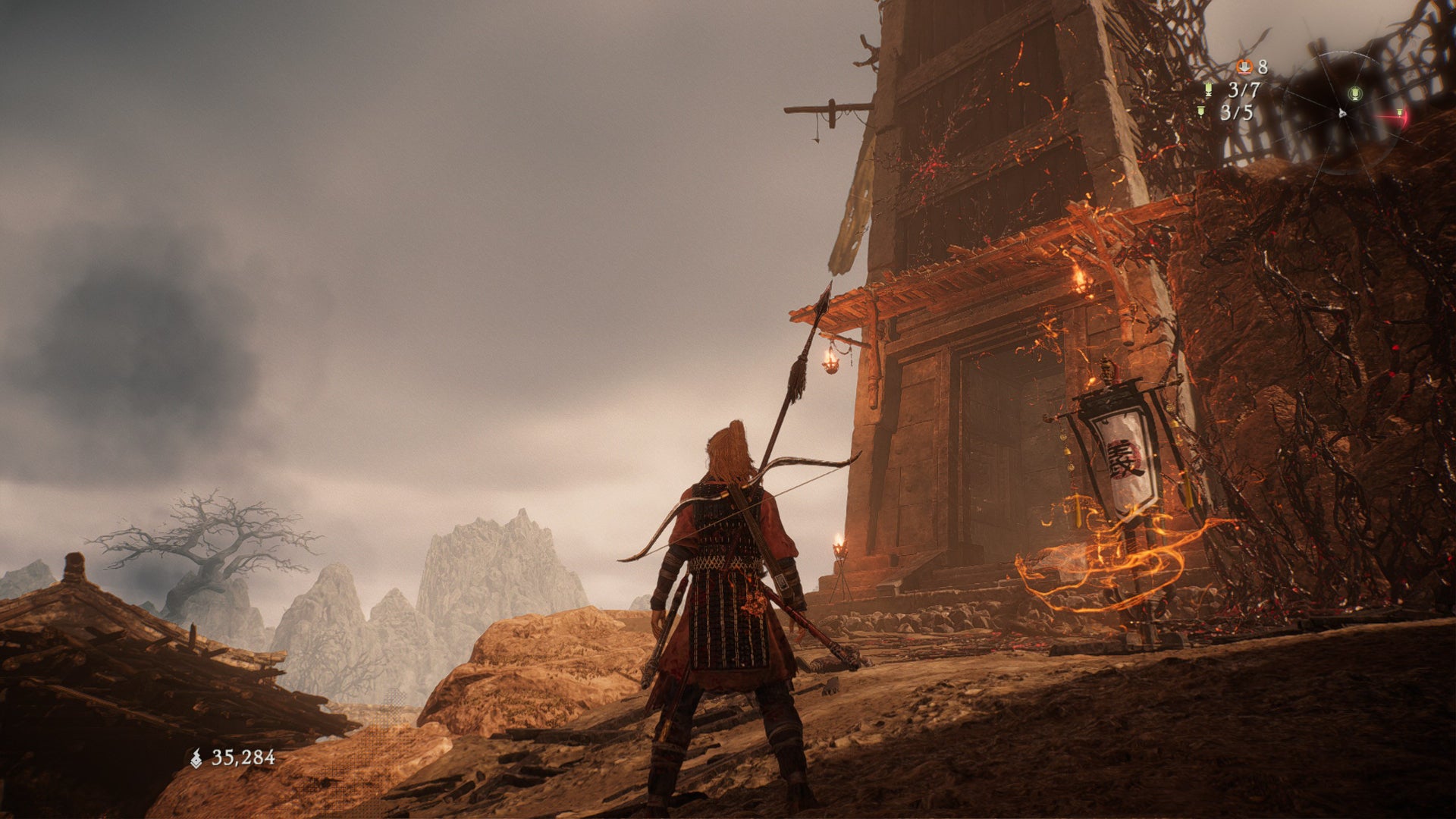 A Wo Long: Fallen Dynasty screenshot of the player standing next to a flag.