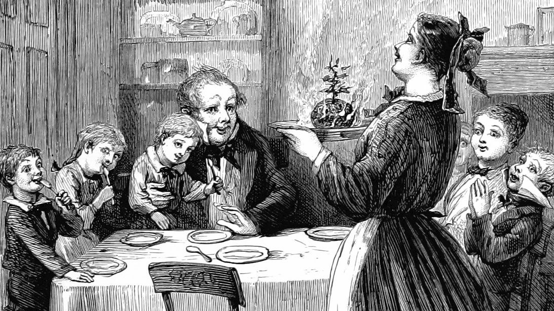 A family sitting round the dinner table excitedly await the delivery of the flaming Christmas pudding in an illustration from 'A Christmas Carol'.